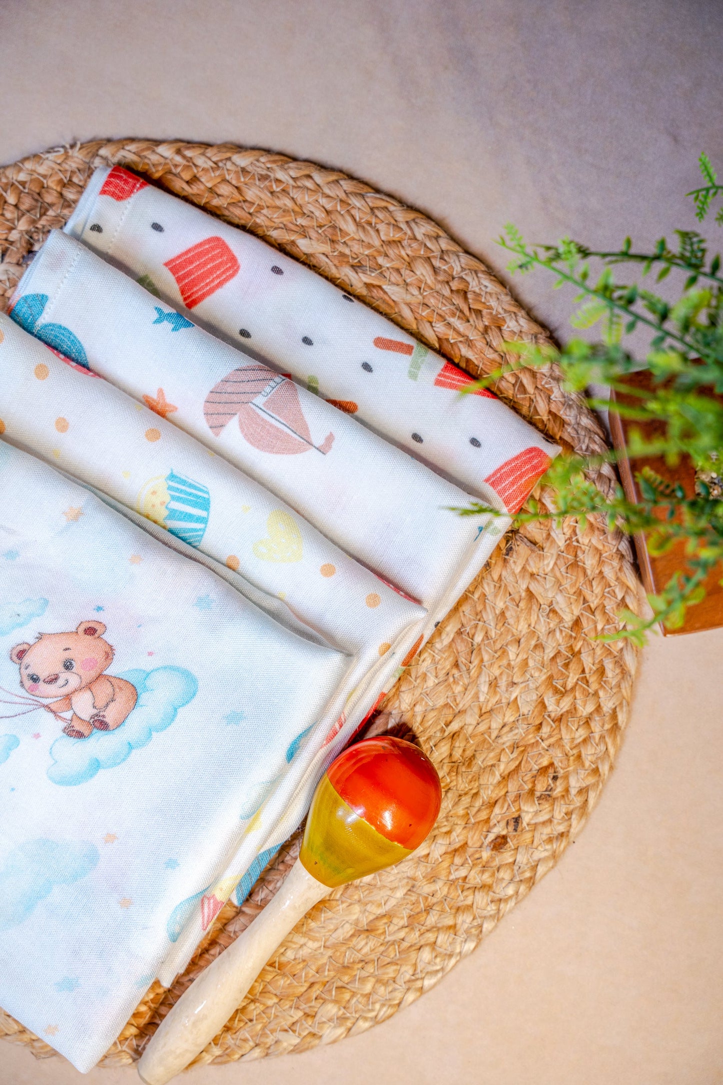 Baby blankets with cartoon designs on a woven basket